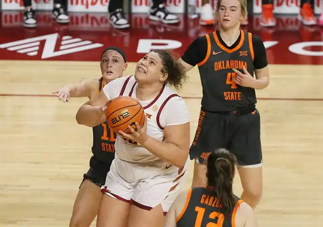 Iowa State Cyclones center Audi Crooks (55) looks for a shot around Oklahoma State Cowgirls guard Rylee Langerman (11), guard Anna Gret Asi (4), and forward Lior Garzon (12) during the second quarter in the Big-12 conference matchup at Hilton Coliseum on Wednesday, Jan. 31, 2024, in Ames, Iowa.