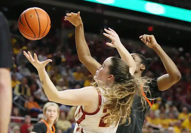 Iowa State Cyclones forward Addy Brown (24) attempts to grab the ball around Oklahoma State Cowgirls guard Quincy Noble (0) during the second quarter in the Big-12 conference matchup at Hilton Coliseum on Wednesday, Jan. 31, 2024, in Ames, Iowa.