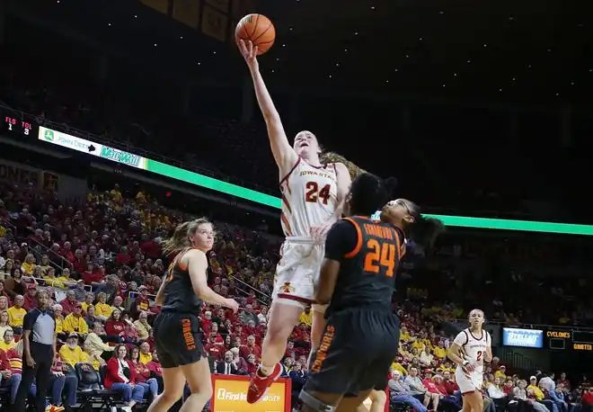 Iowa State Cyclones forward Addy Brown (24) takes a shot over Oklahoma State Cowgirls forward Praise Egharevba (24) during the fourth quarter in the Big-12 conference matchup at Hilton Coliseum on Wednesday, Jan. 31, 2024, in Ames, Iowa.