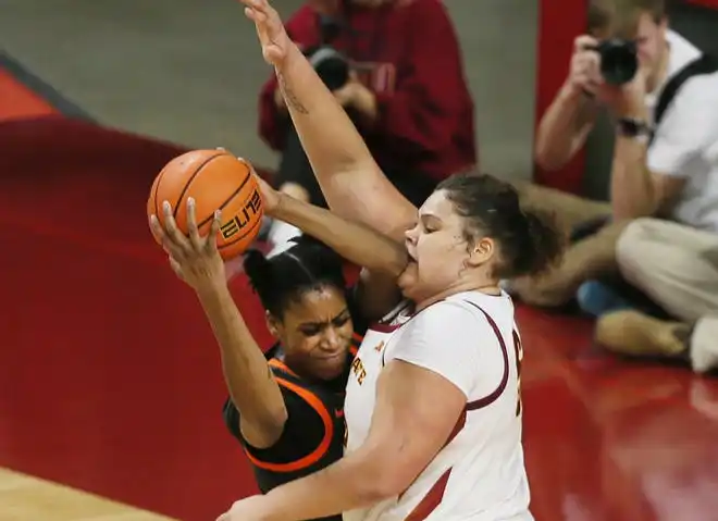 Iowa State Cyclones center Audi Crooks (55) blocks as Oklahoma State Cowgirls forward Praise Egharevba (24) attempts to drives to the basket during the third quarter in the Big-12 conference matchup at Hilton Coliseum on Wednesday, Jan. 31, 2024, in Ames, Iowa.