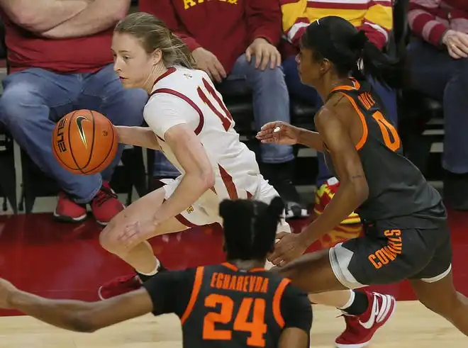 Iowa State Cyclones guard Emily Ryan (11) drives to the basket around Oklahoma State Cowgirls guard Quincy Noble (0) and forward Praise Egharevba (24) during the third quarter in the Big-12 conference matchup at Hilton Coliseum on Wednesday, Jan. 31, 2024, in Ames, Iowa.