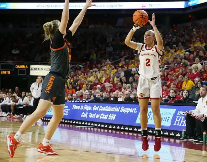 Iowa State Cyclones guard Arianna Jackson (2) takes a three-point shot over Oklahoma State Cowgirls guard Anna Gret Asi (4) during the fourth quarter in the Big-12 conference matchup at Hilton Coliseum on Wednesday, Jan. 31, 2024, in Ames, Iowa.