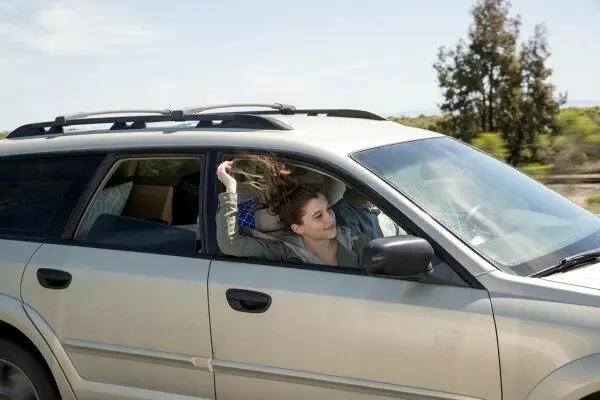 Two people in a car looking at a map.