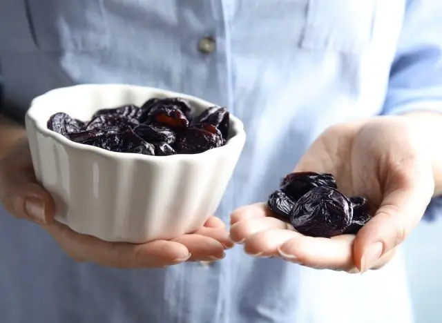 woman holding prunes