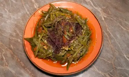 ‘Marinated in a deep sauce of tomato, herbs and garlic’: shredded green beans.