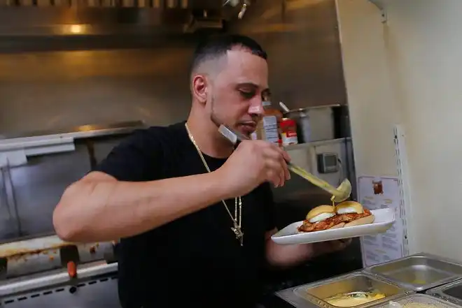 Jason Brooks, co-owner, prepares a poached egg sandwich at the new Toast n' Jam breakfast restaurant on Acushnet Avenue in New Bedford.