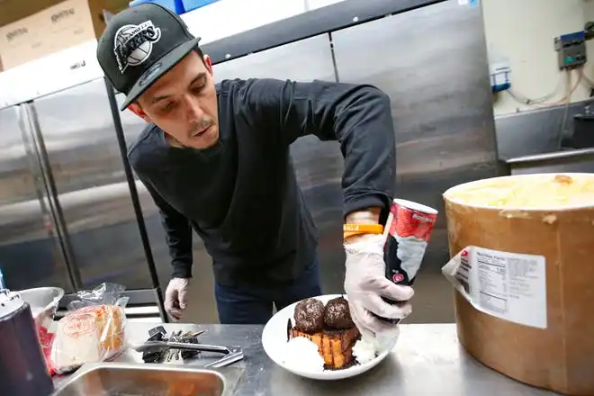 Curtis Medeiros, co-owner, prepares a cookies and cream French toast dish at the new Toast n' Jam breakfast restaurant on Acushnet Avenue in New Bedford.