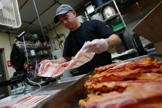 Jimmy Moreira prepares the bacon at the new Toast n' Jam breakfast restaurant on Acushnet Avenue in New Bedford.