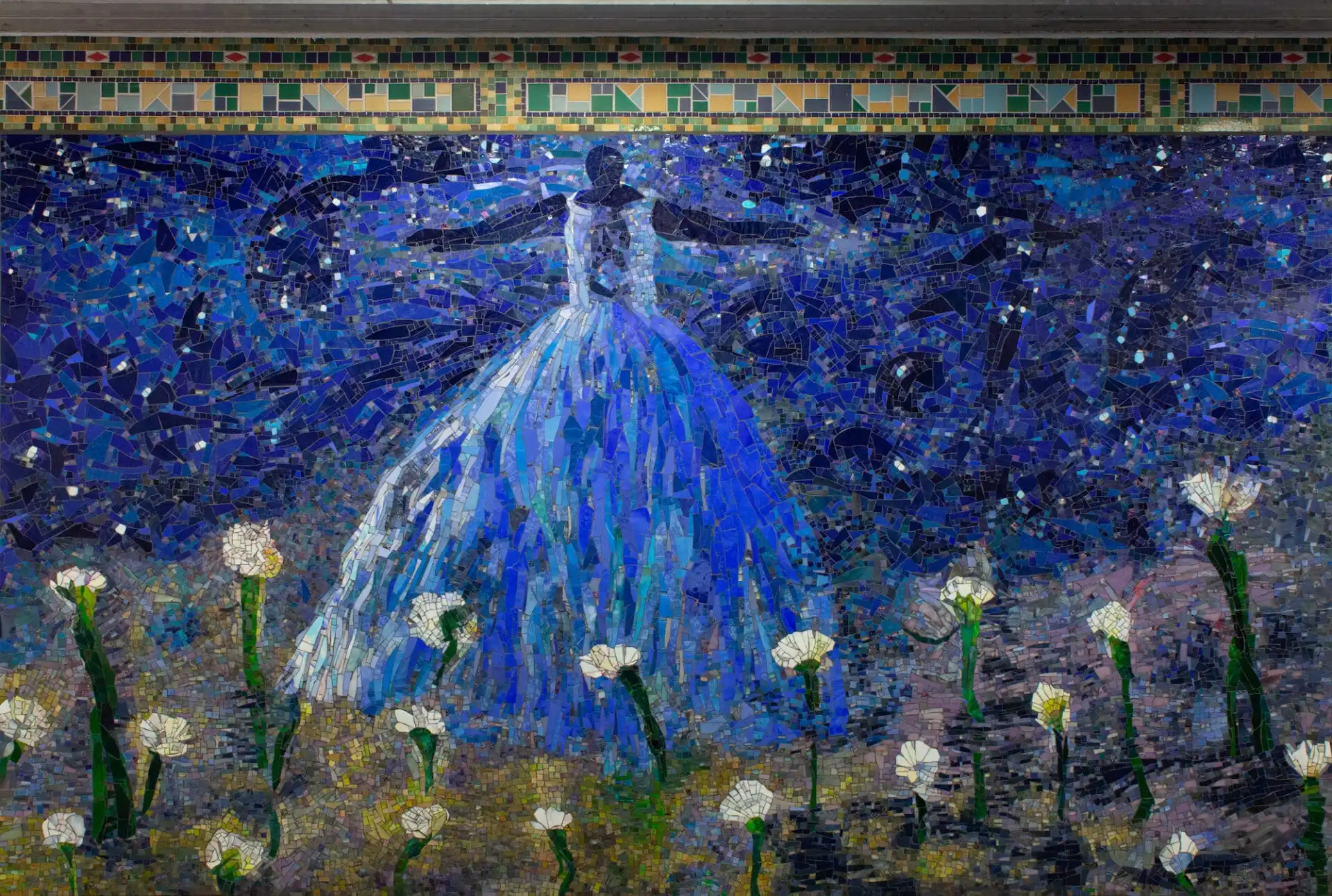 A mosaic by Kathering Bradford of a woman in a blue dress, arms outstretched, in a field of flowers and in front of a night sky.