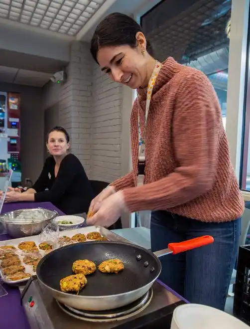 MetroWest YMCA Director of Nutrition Maggie Lynch cooked up sweet potato black bean burgers Feb. 8, 2024 for National Heart Health Month. YMCA Associate Executive Director Lauren Hanley, seated, was promoting a free blood presure self-monitoring and diabetes prevention program set to start in April. The YMCA Wellness Team is celebrating American Heart Month with delicious recipes and taste tests.