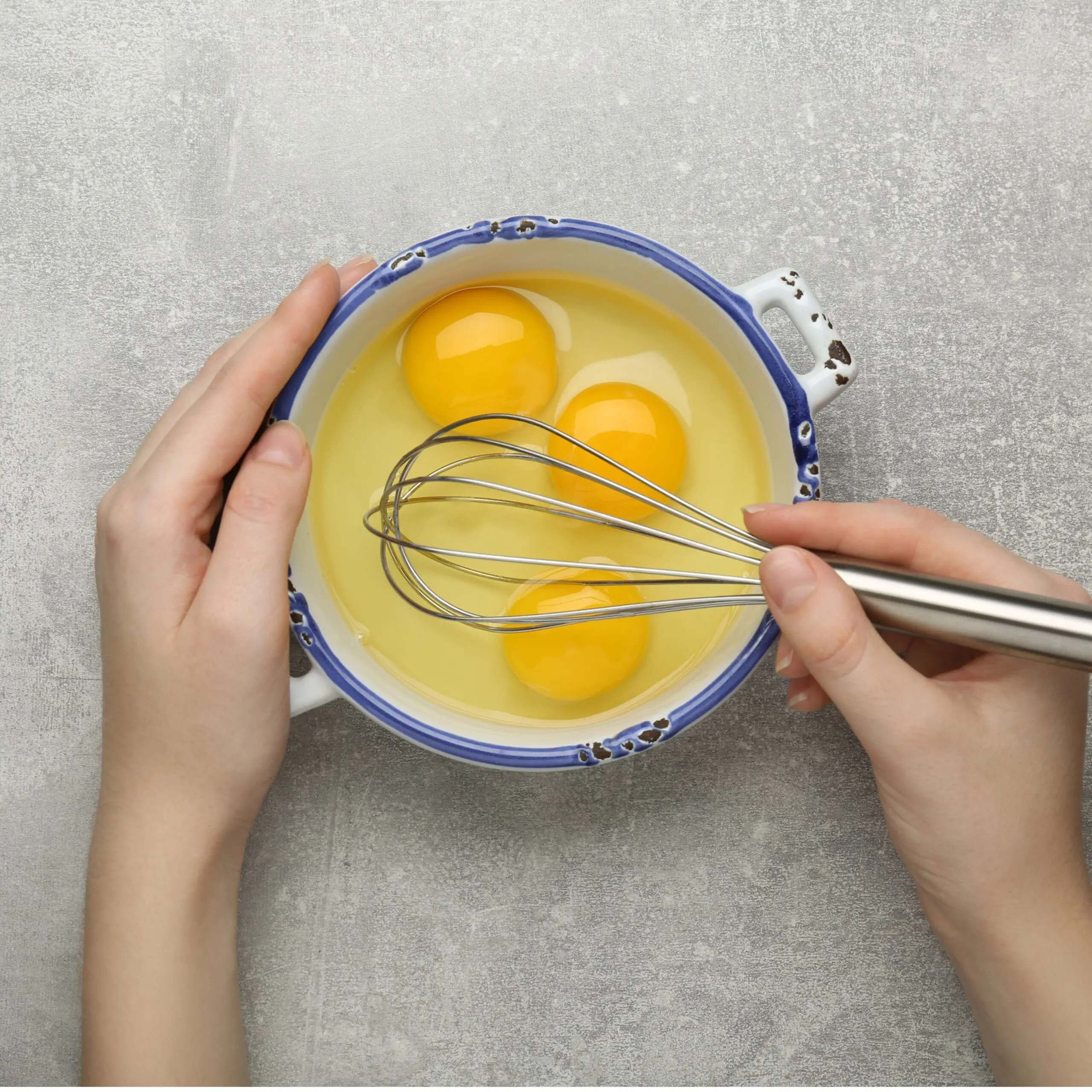 person whisking eggs