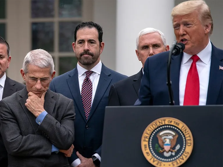 Anthony Fauci stands next to President Trump as he speaks to the nation from White House Amid Coronavirus Pandemic.