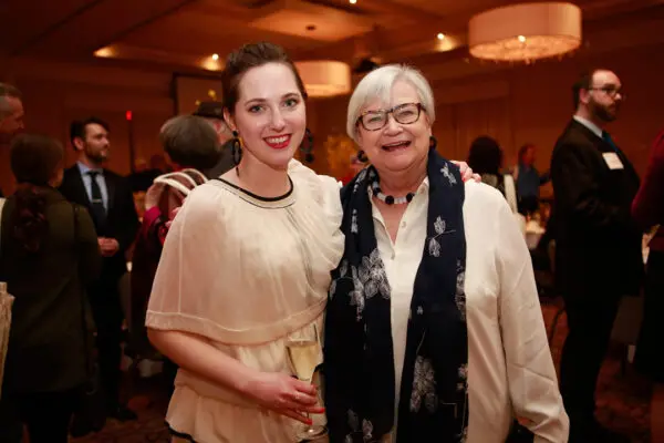 A photograph of two women at an art auction.