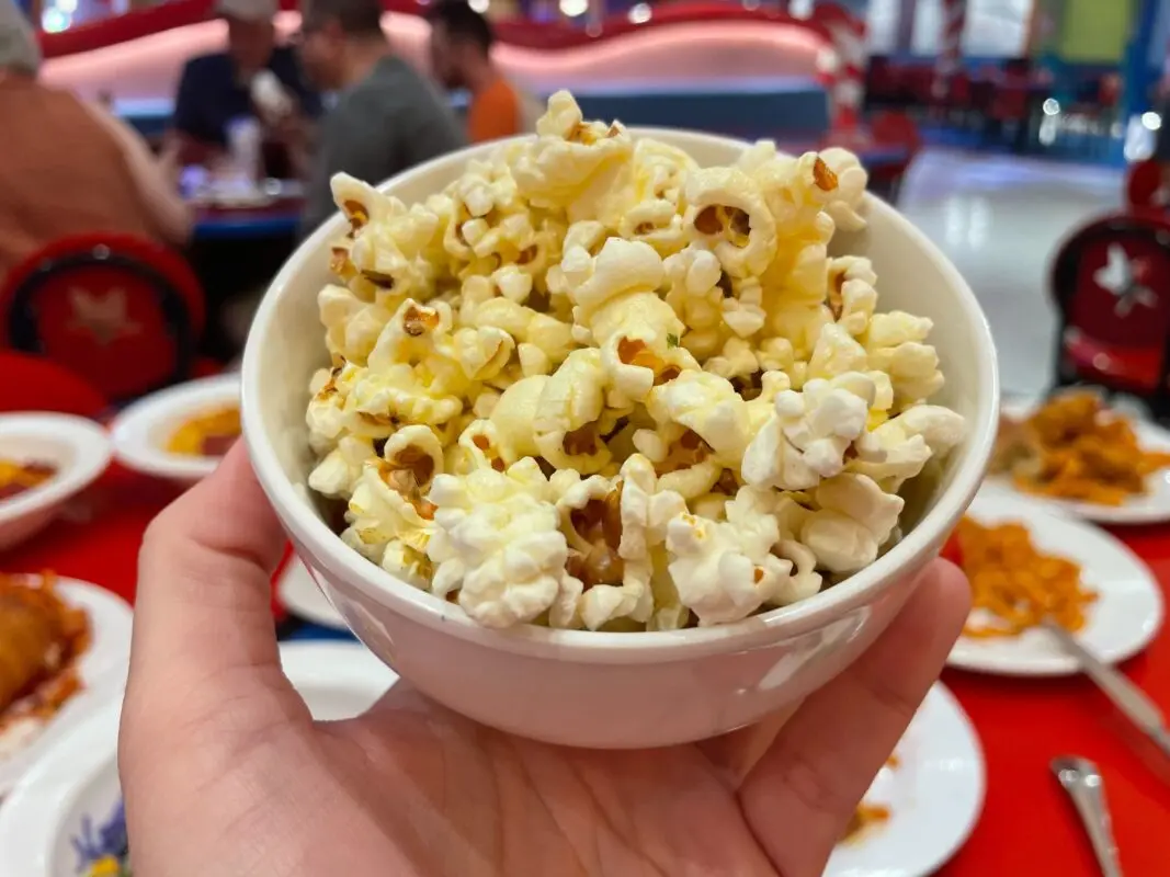 A wide shot of a small bowl filled with garlic popcorn.