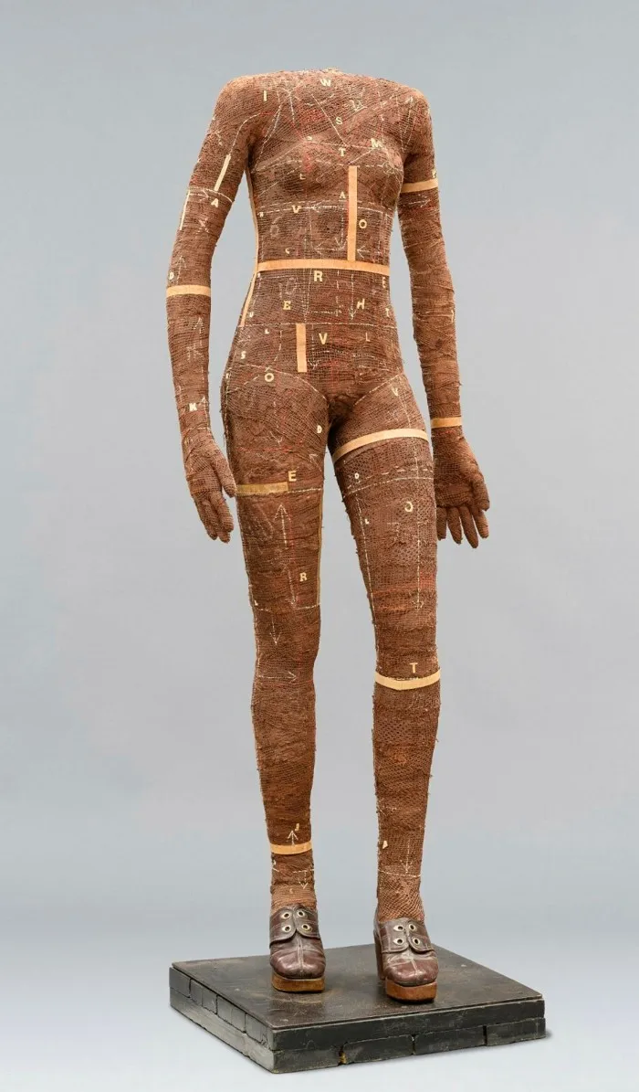 Headless elongated body of a woman made from rattan