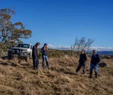 4 people standing near an off-road vehicle on Beauredden property, Jindabye