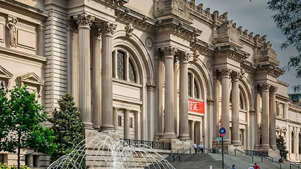 Beige neoclassical exterior of the Metropolitan Museum of Art during the day