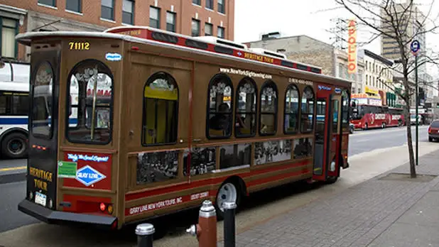 Exterior of a red and gold trolley parked on the street