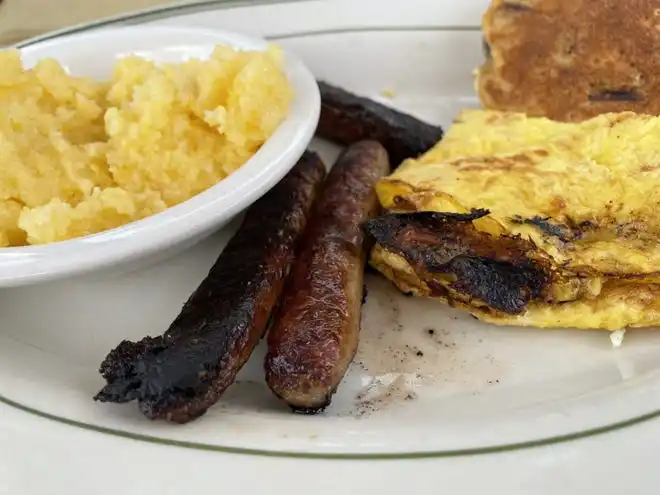 The Local breakfast at Sly Fox Den Too features, from left, nausamp (yellow corn grits), venison sausage, eggs and a corn cake with cranberries.