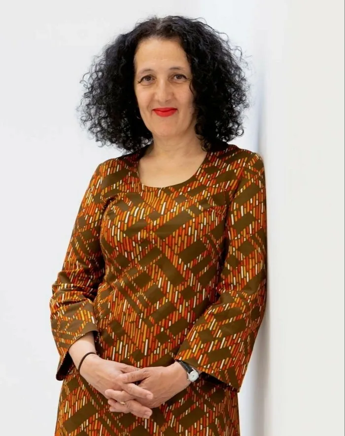 Middle-aged woman with dark curly hair