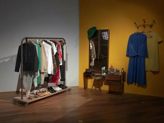Film set with a rack of clothes and dressing table