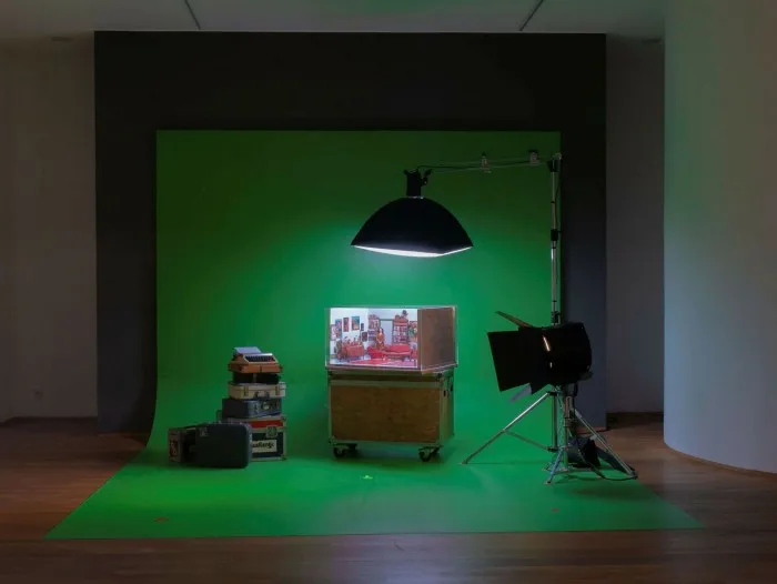 Film set of dolls’ house interior lit by arc lights