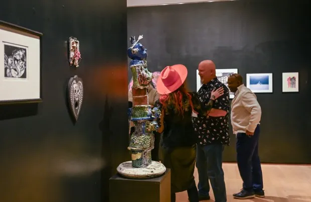 Jessi Hardesty, Mike Hardesty and Clyde Johnson attend the opening reception of the 2nd Biennial Carroll Community College Faculty Exhibition.(Karen Jackson/Freelance)