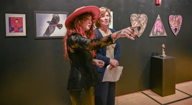 Jessi Hardesty and Rose Mince look at the artwork during opening reception of the 2nd Biennial Carroll Community College Faculty Exhibition.(Karen Jackson/Freelance)