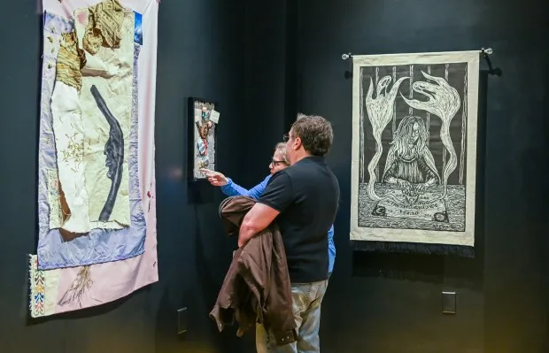 Ed Maiello and Sarah Abel-Deluca look at her found object assemblage during the opening reception of 2nd Biennial Carroll Community College Faculty Exhibition.(Karen Jackson/Freelance)