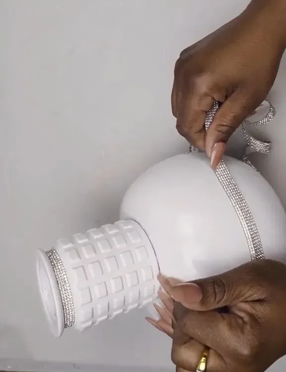 The DIY enthusiast spray-painted her homemade vase white and added metallic ribbons as a finishing touch