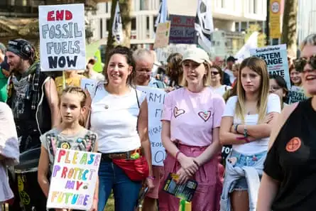 Katherine Ryan and daughter Violet with Sophie Broadbent and family at a protest march in Parental Guidance.