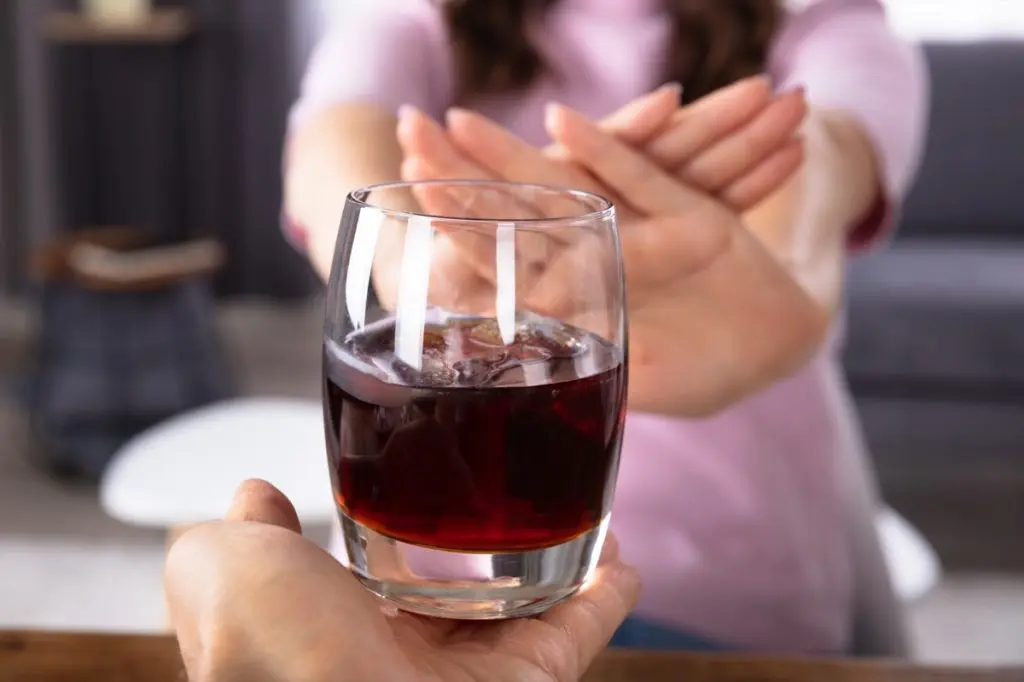 woman saying no to an alcoholic drink