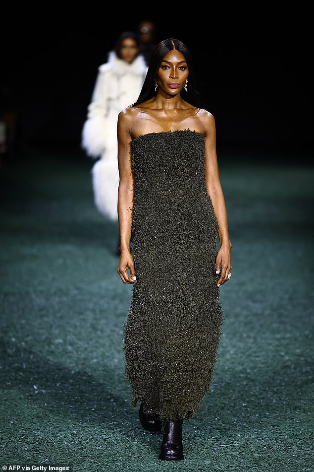 Naomi Campbell slips into a dazzling beaded gown during Burberry show