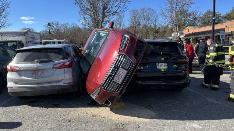 One taken to hospital after car lands on top of two other vehicles in Wellesley