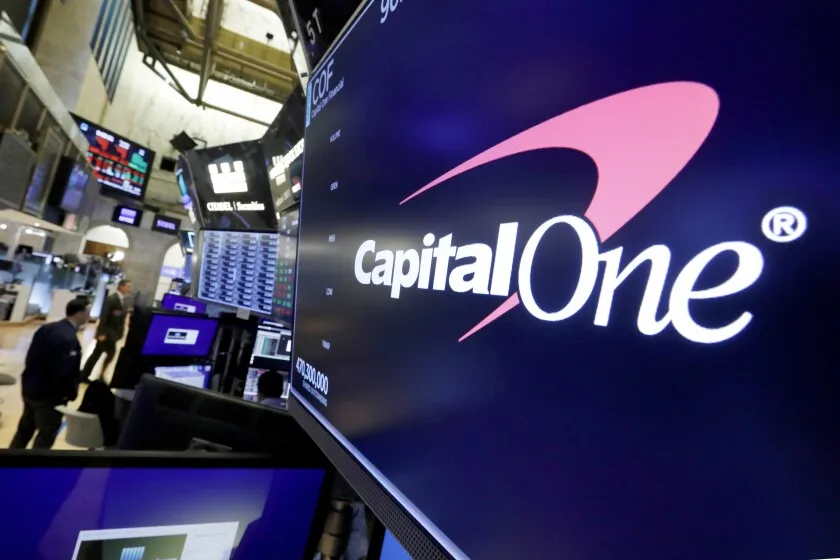 Capitol One DiscoverFILE - The logo for Capital One Financial is displayed above a trading post on the floor of the New York Stock Exchange, July 30, 2019. Capital One Financial is buying Discover Financial Services for $35 billion, in a deal that would bring together two of the nation's biggest lenders and credit card issuers, according to a news release issued by the companies Monday, Feb. 19, 2024. (AP Photo/Richard Drew, File) ORG XMIT: NYCD303