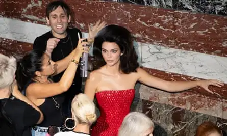 A hair stylist oversees Kendall Jenner’s bouffant at a Schiaparelli show.