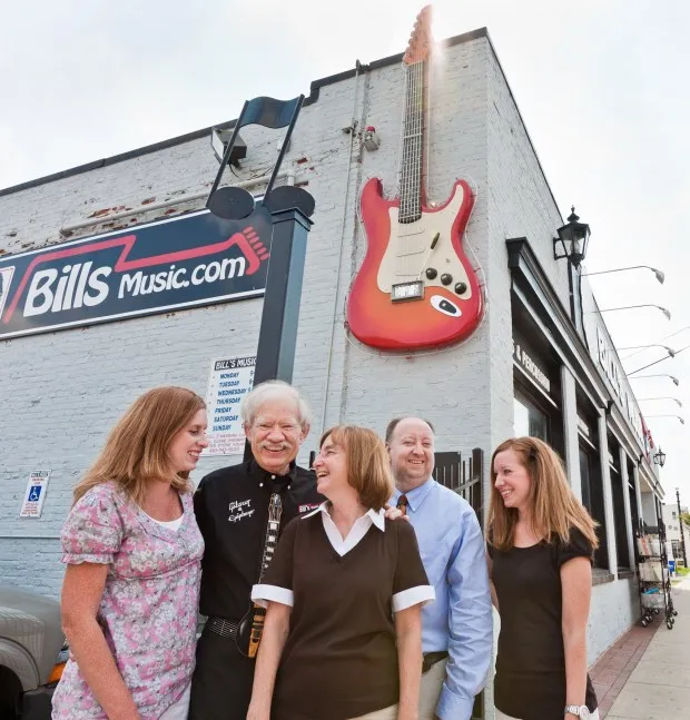 The Higgins Family, owners of Bill's Music in Catonsville, pose outside the store in 2010 by the giant guitar that famously marks the building. Pictured from left is daughter Tracey Kern, founder and father Bill Higgins, Nancy Higgins, son Brian Higgins, and daughter Jamie Reese.