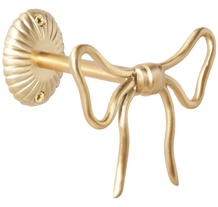 a bow-shaped cast brass accessory used to tie back curtains