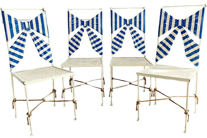 Four wrought-iron chairs with bows as their backrests