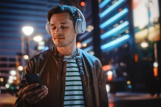 homem ouvindo algo no celular na rua 