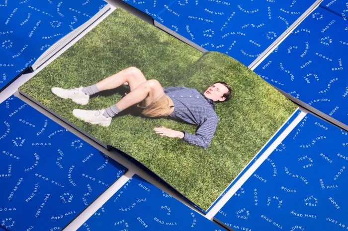 A book with a picture of a man on the grass