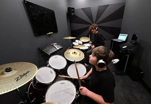 School of Rock student Benjamin Cosgrove, 10, front, goes through a drum lesson with teacher Ben Eberley Tuesday, Feb. 20, 2024, at School of Rock's new location in Loveland. (Jenny Sparks/Loveland Reporter-Herald)