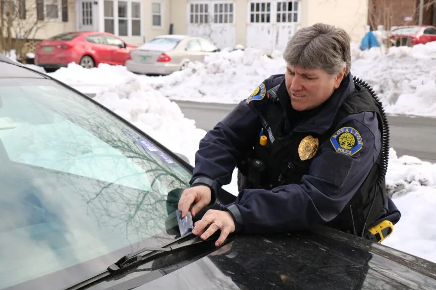 Royalton Police Chief Loretta Stalnaker leaves her card on a car involved with a parking lot dispute. Stalnaker says first responders in small rural departments need mental health support as much as those in larger, more urban departments.