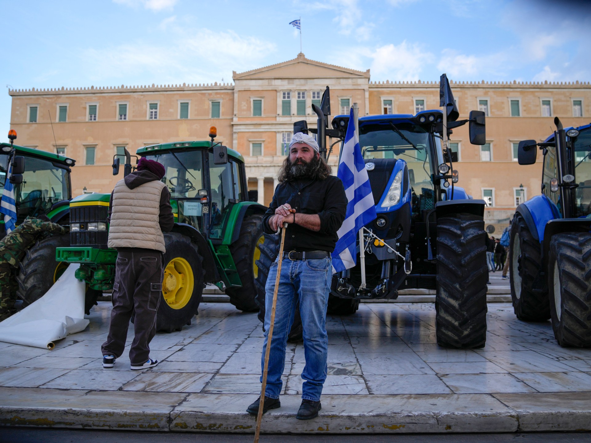 Photos: Greek farmers drive tractors to parliament to demand financial help