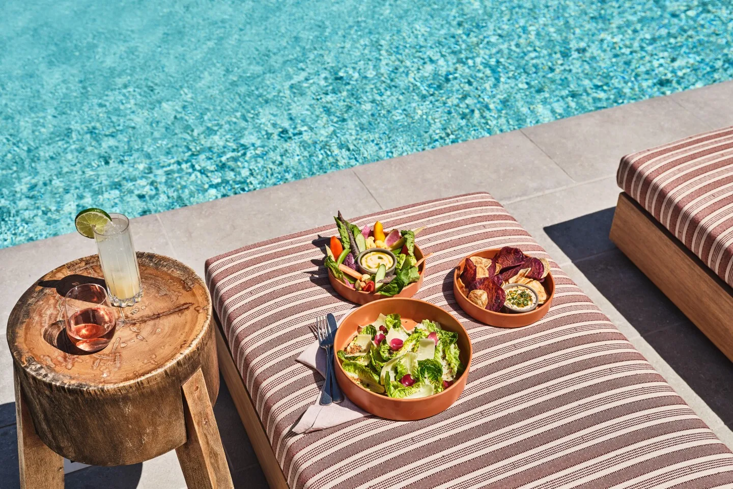 Food and beverage around a poolside lounge chair at The Inn at Mattei’s Tavern