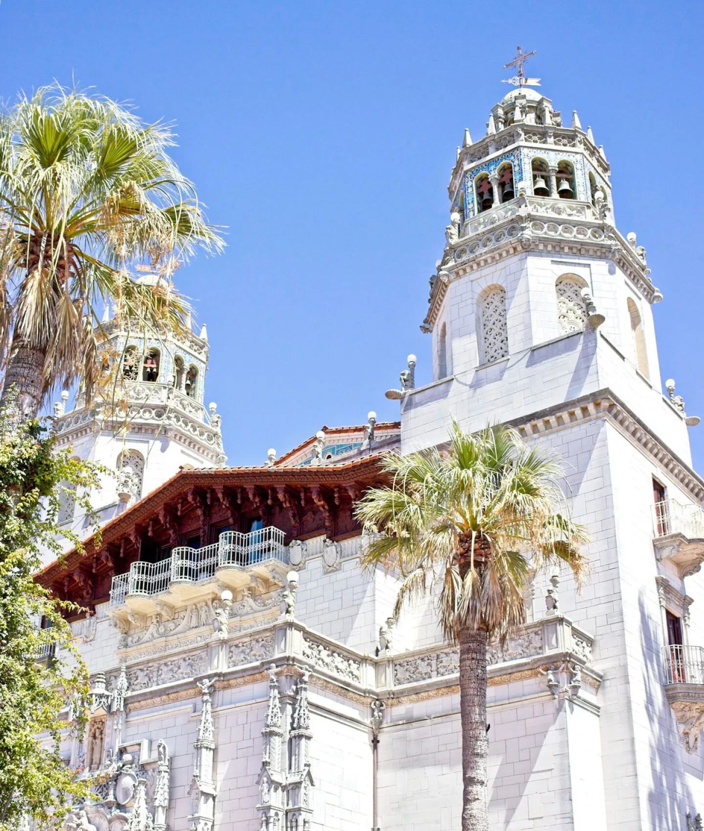 Hearst Castle flanked by palm trees