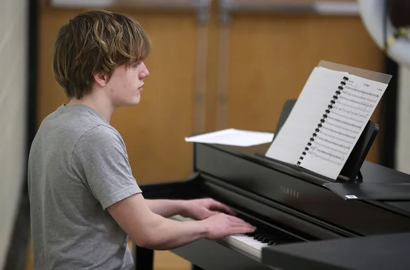 Student plays piano.