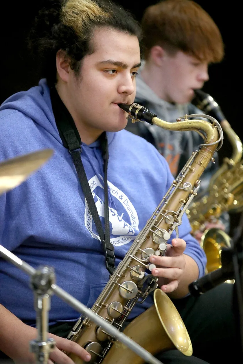 students play saxophones.