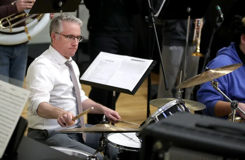 Band director plays drums.