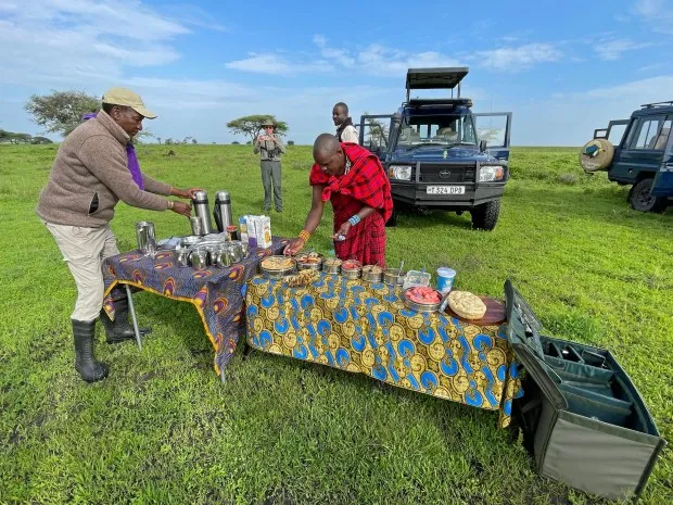 An al fresco breakfast, arranged in the Serengeti bush by our Wilderness Travel team, includes vegetable quiche and a view of migrating herds. (Photo by Norma Meyer)